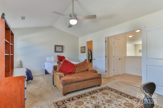 carpeted living area featuring vaulted ceiling, ceiling fan, visible vents, and baseboards