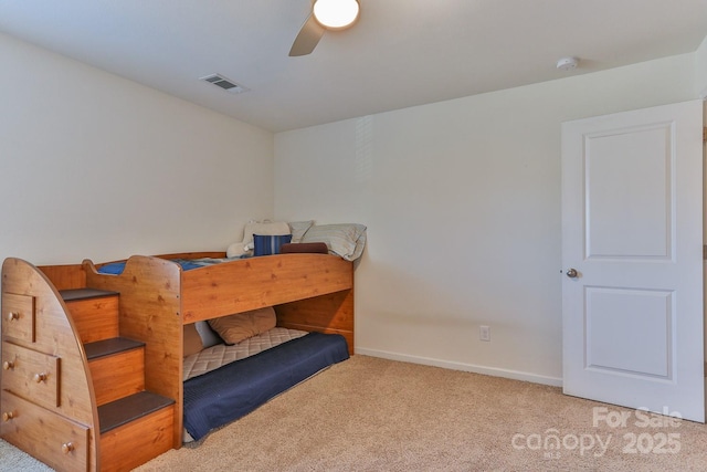 carpeted bedroom featuring baseboards, visible vents, and a ceiling fan