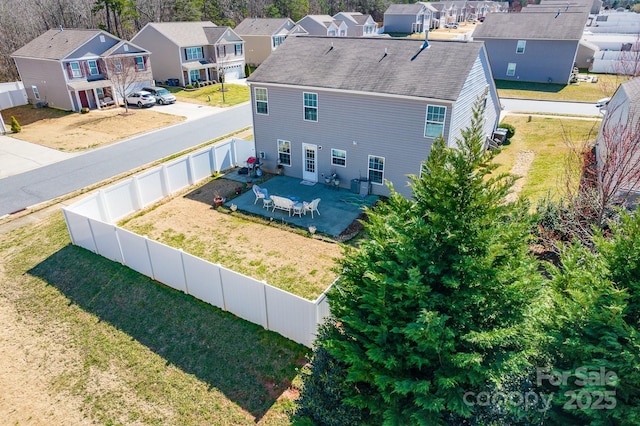 birds eye view of property with a residential view