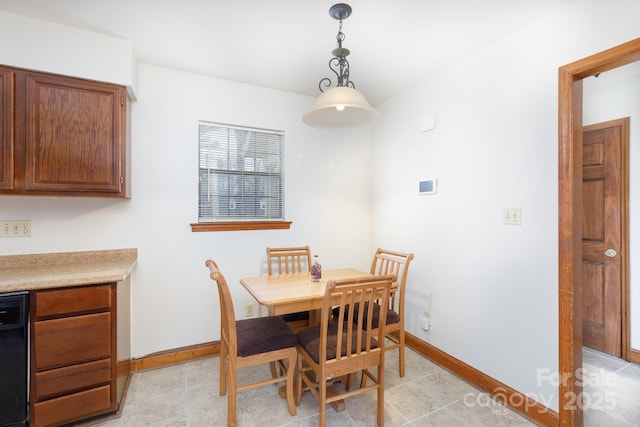 dining area featuring light tile patterned floors and baseboards