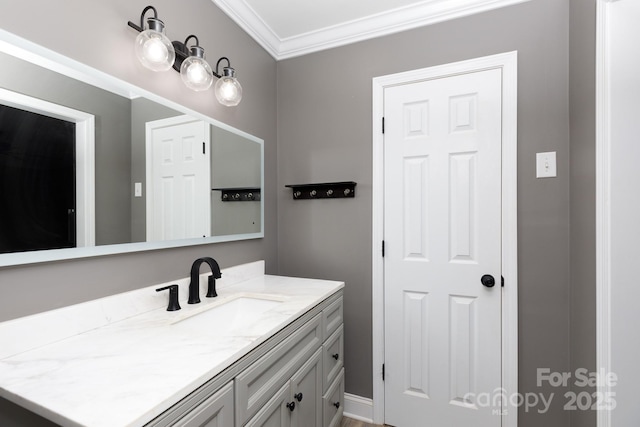 bathroom featuring ornamental molding and vanity