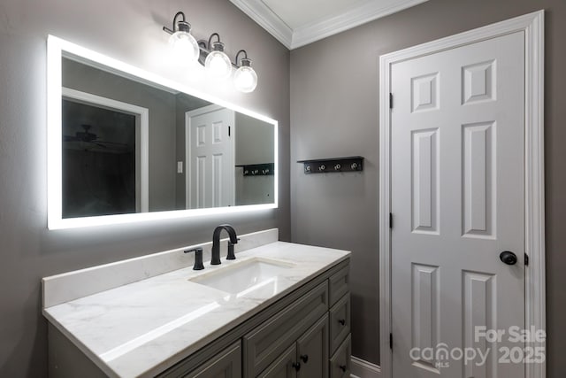 bathroom with ceiling fan, vanity, and crown molding