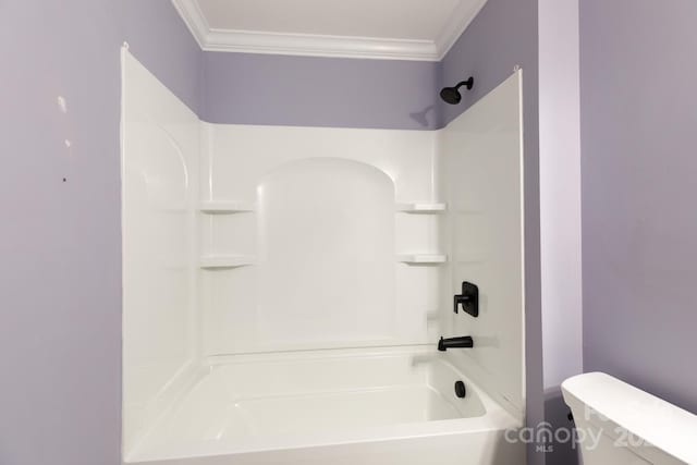 bathroom featuring toilet, ornamental molding, and shower / bathtub combination