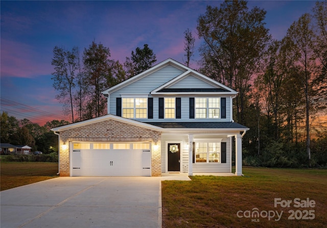 traditional home featuring concrete driveway, brick siding, an attached garage, and a front lawn
