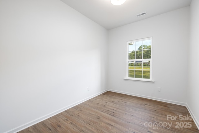 unfurnished room with wood finished floors and baseboards