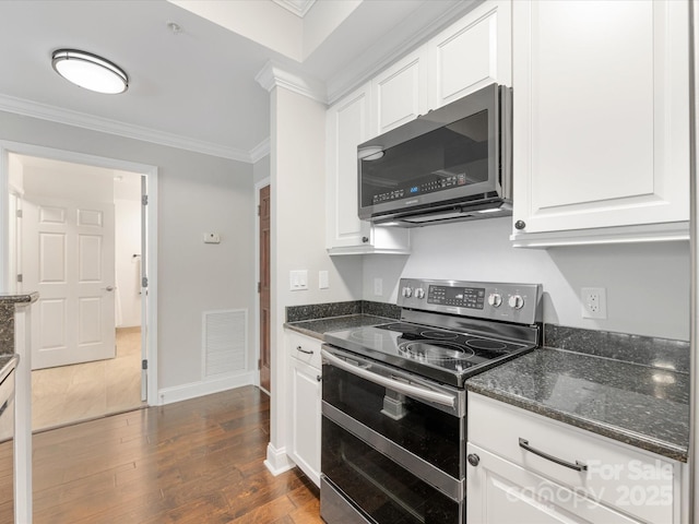 kitchen with appliances with stainless steel finishes, white cabinets, visible vents, and crown molding