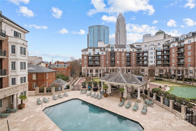 pool featuring a patio, a gazebo, and fence