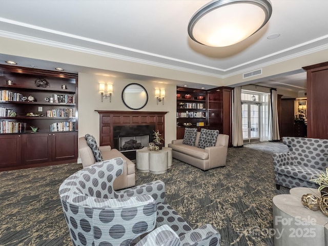 living area featuring visible vents, carpet flooring, and ornamental molding