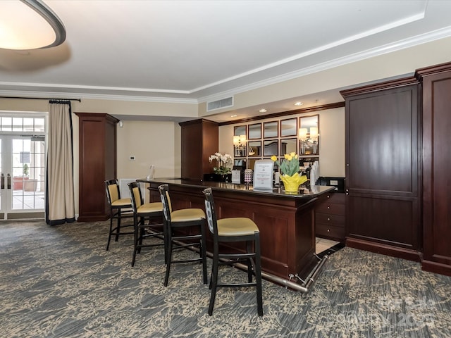 bar featuring french doors, crown molding, visible vents, dark carpet, and a bar