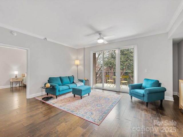 living room with ornamental molding, wood finished floors, a ceiling fan, and baseboards