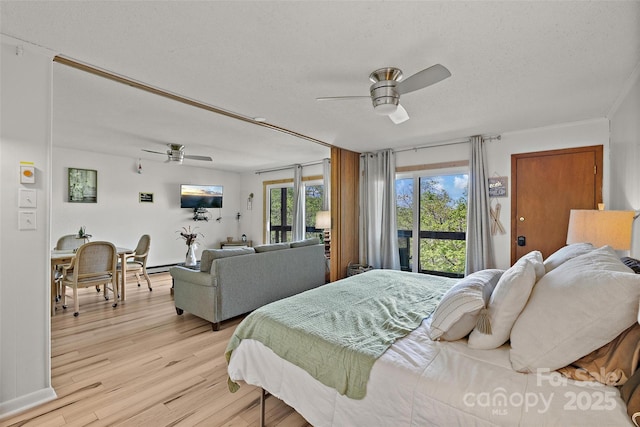 bedroom featuring a textured ceiling, access to outside, light wood finished floors, and ceiling fan