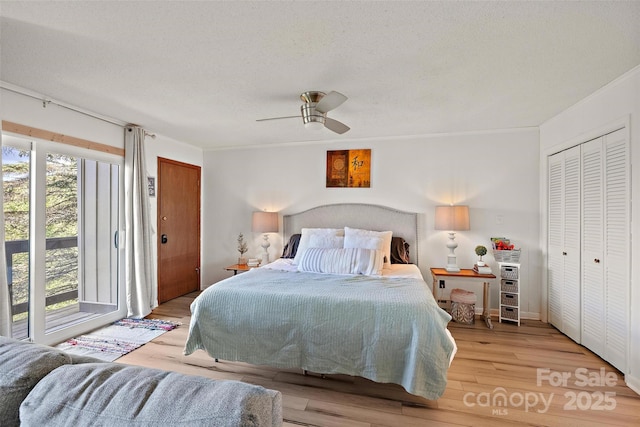 bedroom featuring a textured ceiling, a ceiling fan, and wood finished floors