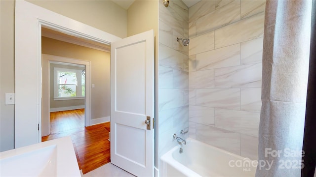 full bath featuring shower / tub combination, baseboards, and wood finished floors