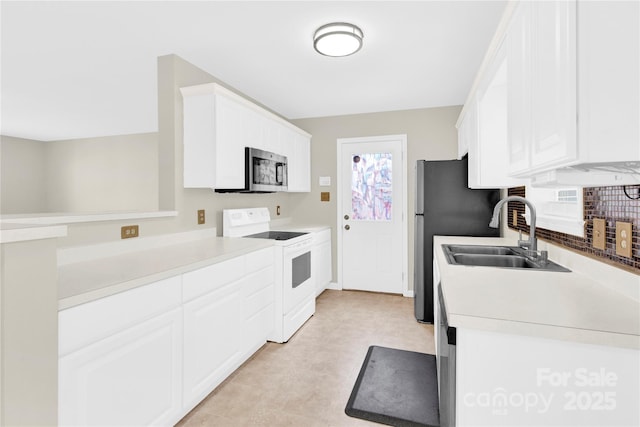 kitchen featuring a sink, white cabinets, light countertops, stainless steel microwave, and white electric range oven