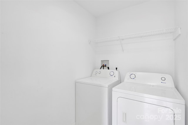 washroom featuring laundry area and washer and clothes dryer