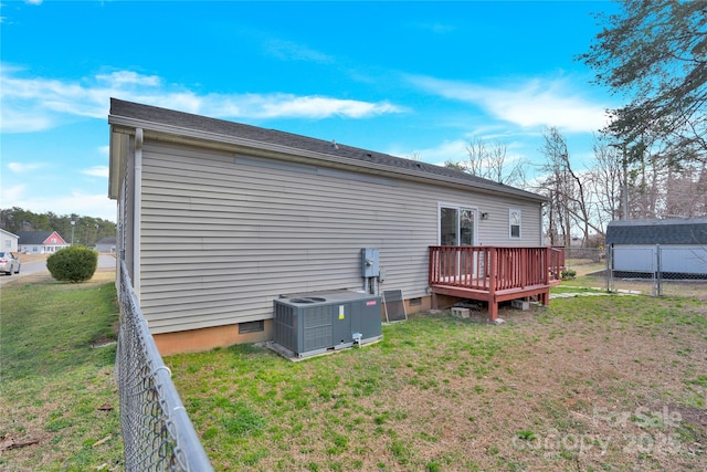 rear view of house featuring central air condition unit, a lawn, crawl space, fence, and a wooden deck