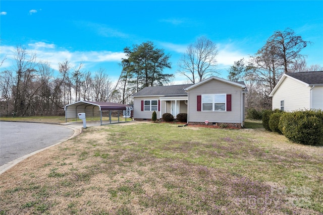 ranch-style home featuring crawl space, driveway, a carport, and a front yard