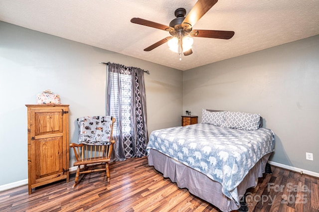 bedroom with baseboards, ceiling fan, wood finished floors, and a textured ceiling