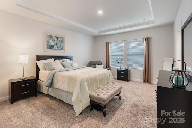 bedroom featuring a raised ceiling, crown molding, light colored carpet, and baseboards