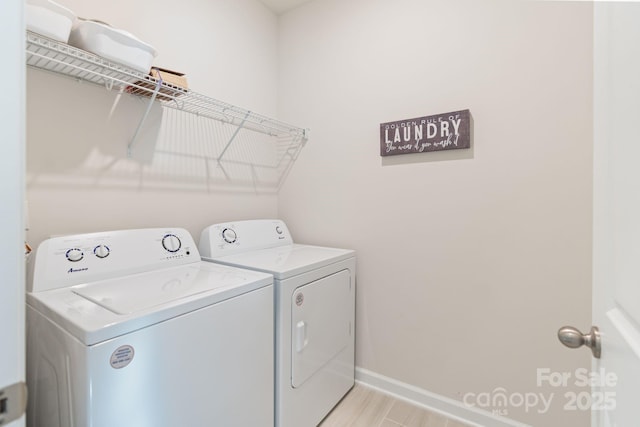 laundry room with laundry area, baseboards, and washing machine and clothes dryer