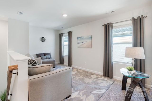 living room with recessed lighting, visible vents, baseboards, and light colored carpet