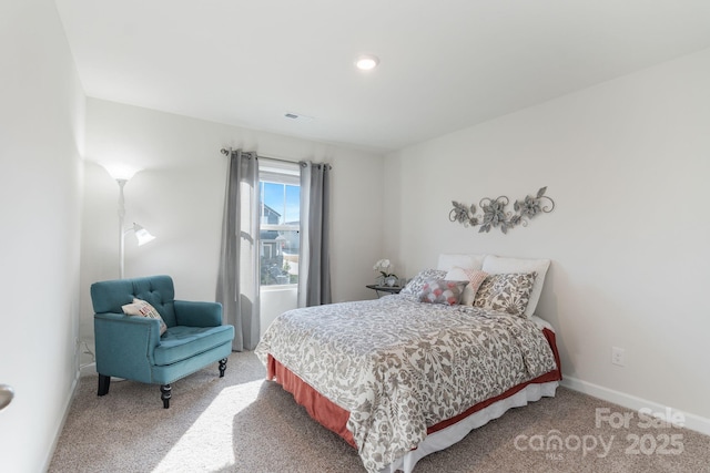 bedroom with visible vents, baseboards, and light colored carpet