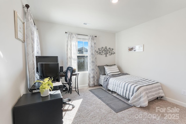 carpeted bedroom featuring baseboards and visible vents