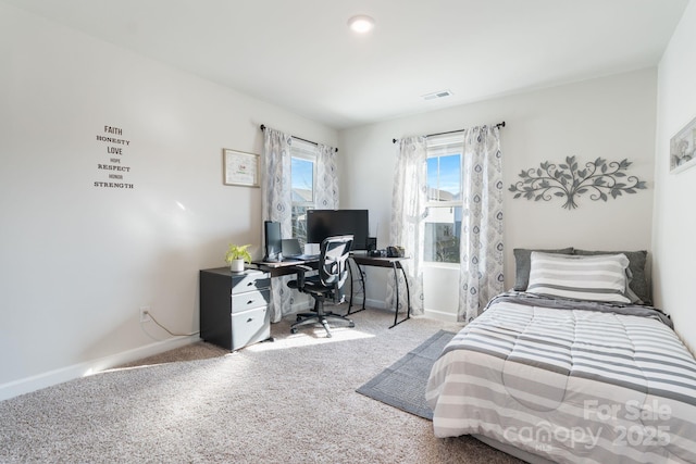 carpeted bedroom with visible vents and baseboards