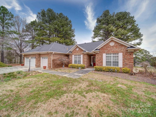 ranch-style house featuring a front yard, an attached garage, a shingled roof, concrete driveway, and brick siding