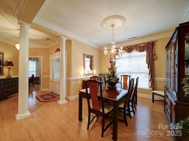 dining room featuring visible vents, light wood-type flooring, and decorative columns