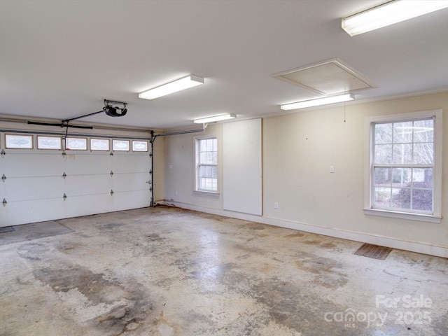 garage featuring a garage door opener and baseboards