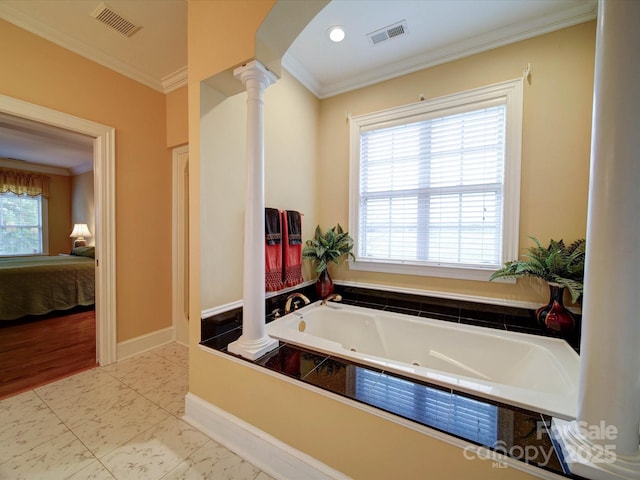 ensuite bathroom with visible vents, ensuite bathroom, crown molding, and ornate columns