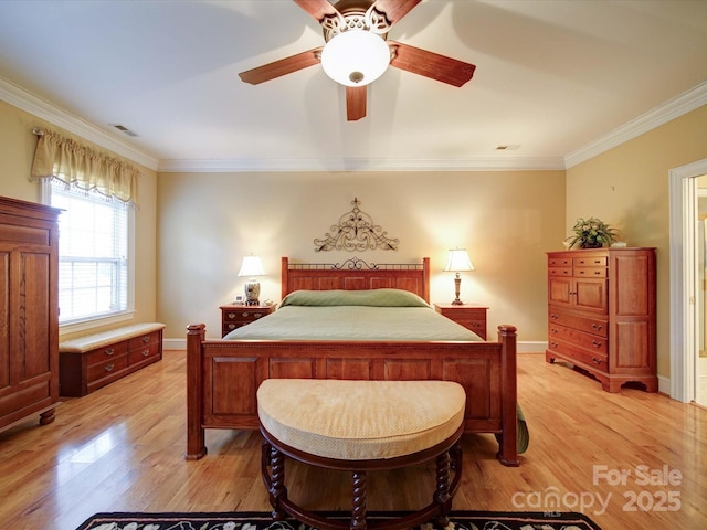 bedroom with light wood-type flooring, visible vents, baseboards, and ornamental molding