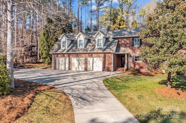 view of front of home featuring a front lawn, concrete driveway, and brick siding