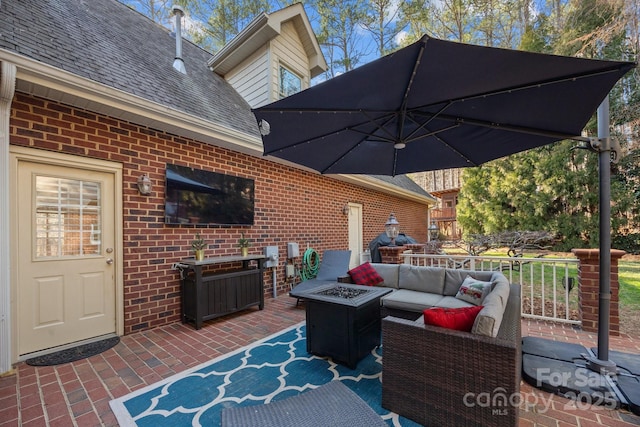 deck featuring a patio area and an outdoor living space with a fire pit