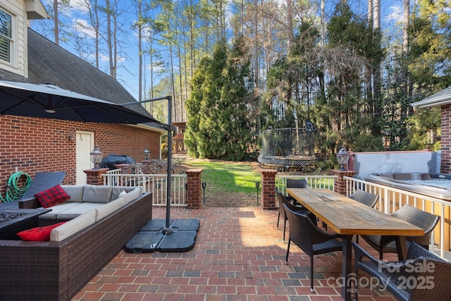 view of patio featuring an outdoor hangout area, outdoor dining space, and a trampoline