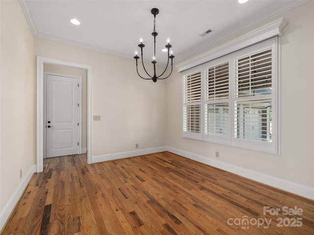 interior space with an inviting chandelier, baseboards, ornamental molding, and wood finished floors