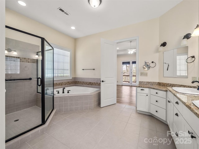 full bathroom featuring a garden tub, a shower stall, vanity, and tile patterned floors