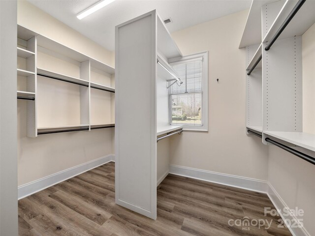 spacious closet with visible vents and wood finished floors