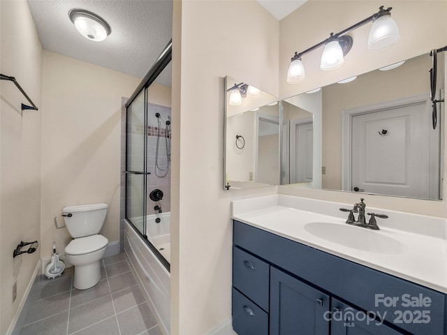 bathroom with bath / shower combo with glass door, toilet, vanity, a textured ceiling, and tile patterned flooring