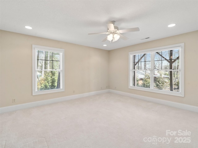 empty room with visible vents, baseboards, a ceiling fan, light colored carpet, and recessed lighting