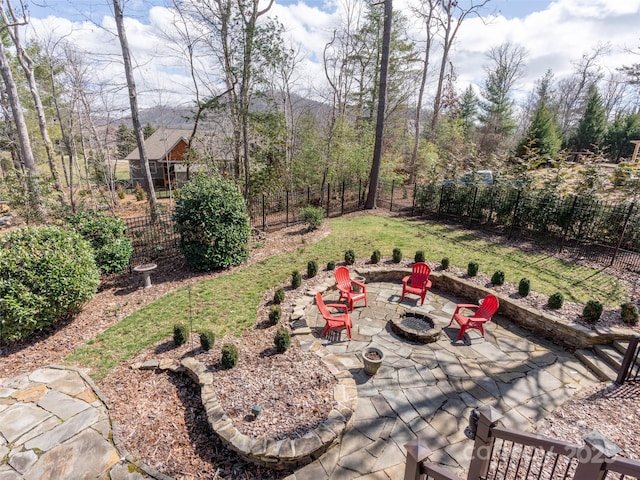 view of yard with a patio area, an outdoor fire pit, and a fenced backyard