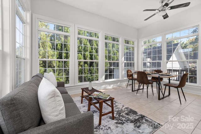 sunroom / solarium featuring ceiling fan