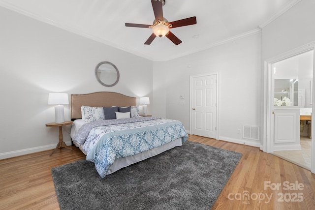 bedroom with ceiling fan, wood finished floors, visible vents, baseboards, and crown molding