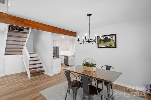 dining space with light wood-type flooring, baseboards, beamed ceiling, and stairs