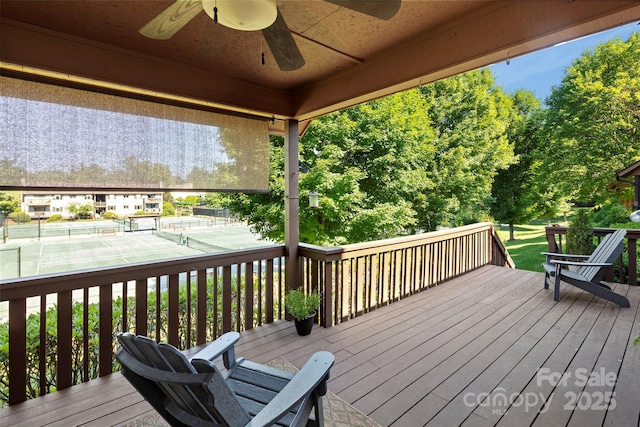 wooden terrace featuring a tennis court