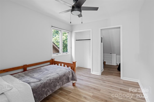 bedroom featuring a closet, baseboards, ceiling fan, and light wood finished floors