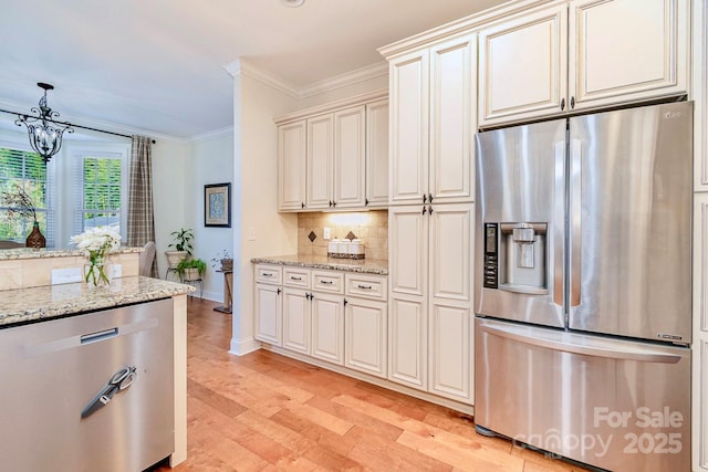 kitchen with light stone countertops, stainless steel appliances, light wood-style floors, crown molding, and tasteful backsplash