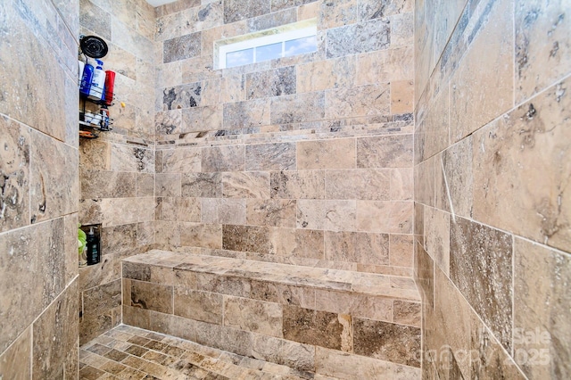 full bath with a tile shower