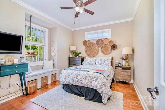 bedroom featuring baseboards, wood finished floors, and ornamental molding